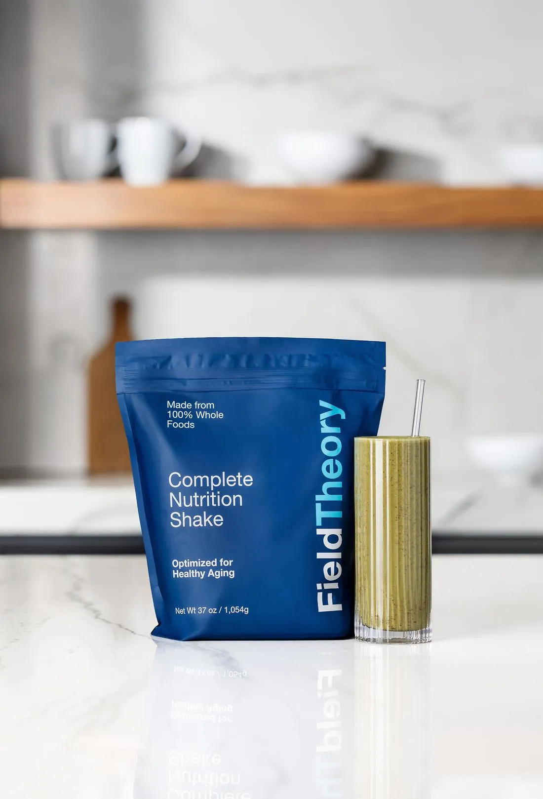 Field Theory pouch beside a glass of the prepared shake